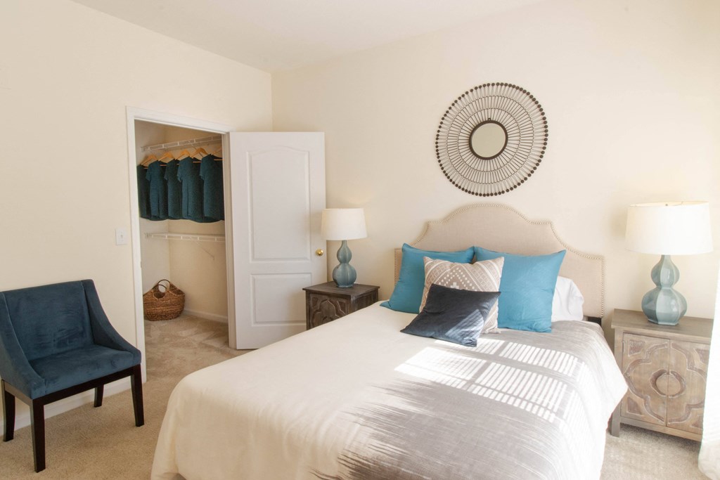 A bedroom with a large bed and a chair. at The Crest at Sugarloaf, Georgia, 30044