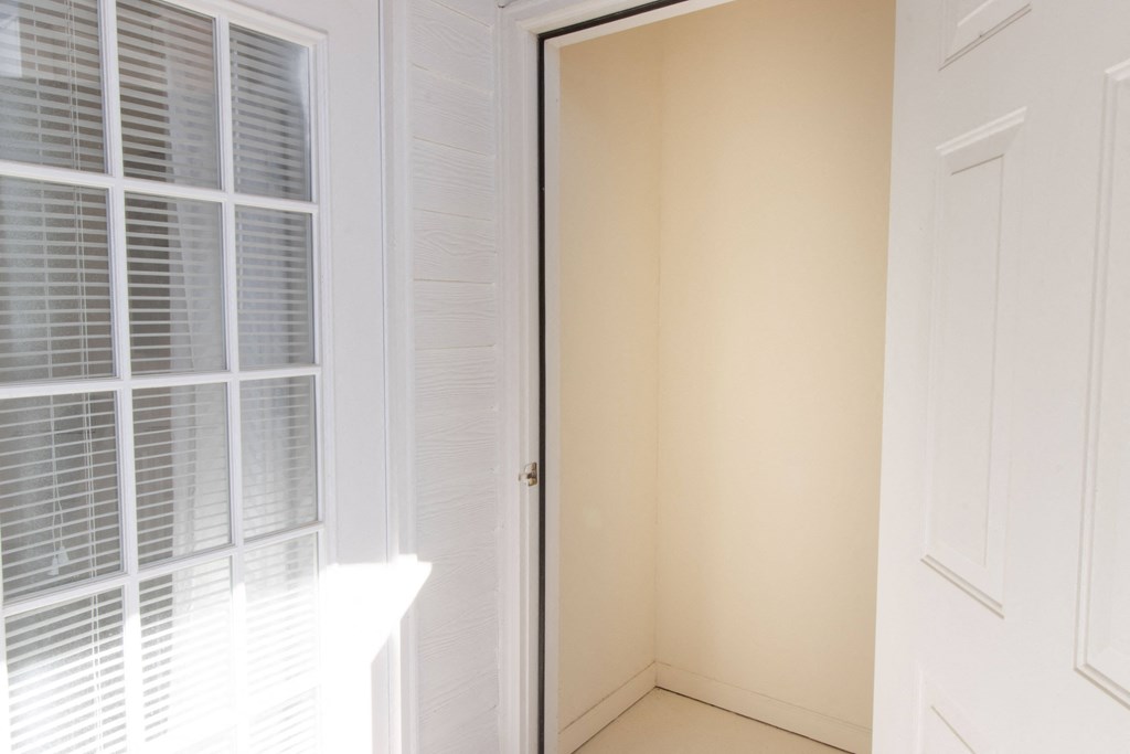 A white door is open to a hallway. at The Crest at Sugarloaf, Lawrenceville, Georgia