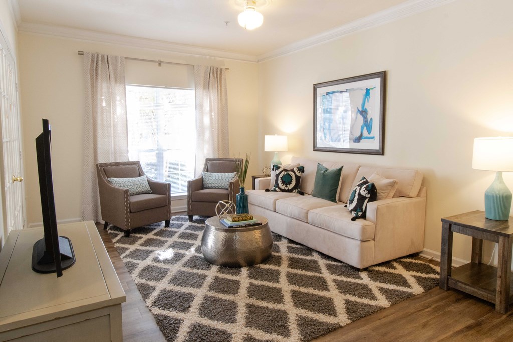 A living room with a couch, chairs, and a rug. at The Crest at Sugarloaf, Georgia, 30044
