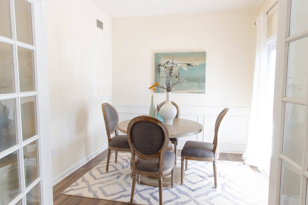 A dining room with a table and chairs. at The Crest at Sugarloaf, Lawrenceville, 30044