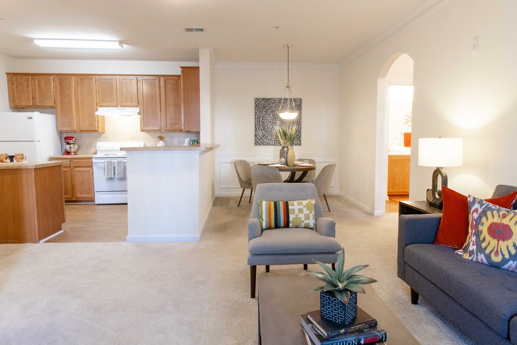 A living room with a grey couch and a coffee table. at The Crest at Sugarloaf, Georgia