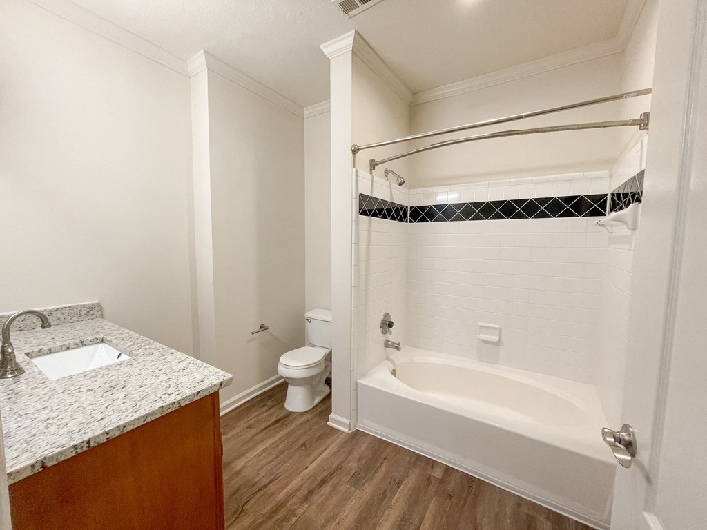 Apartment Home Bathroom with Wood Style Plank Flooring and Vanity located in Lawrenceville, GA