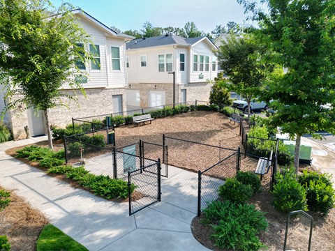 A playground with a swing set and a basketball hoop.