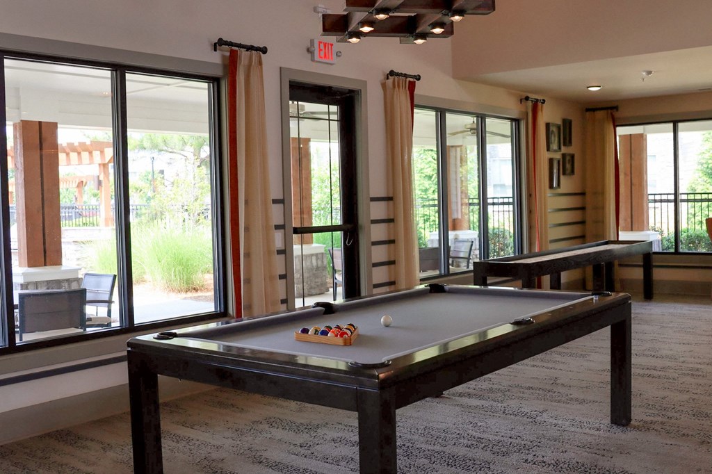 a game room with a pool table and a ping pong table