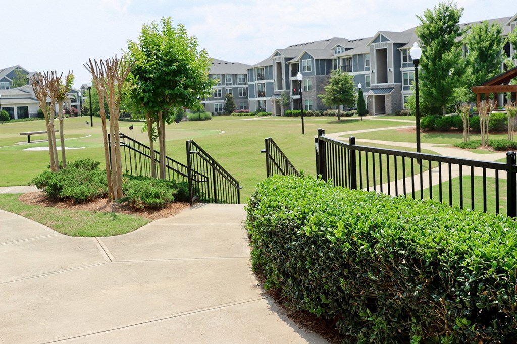 an apartment complex with a golf course in front of it