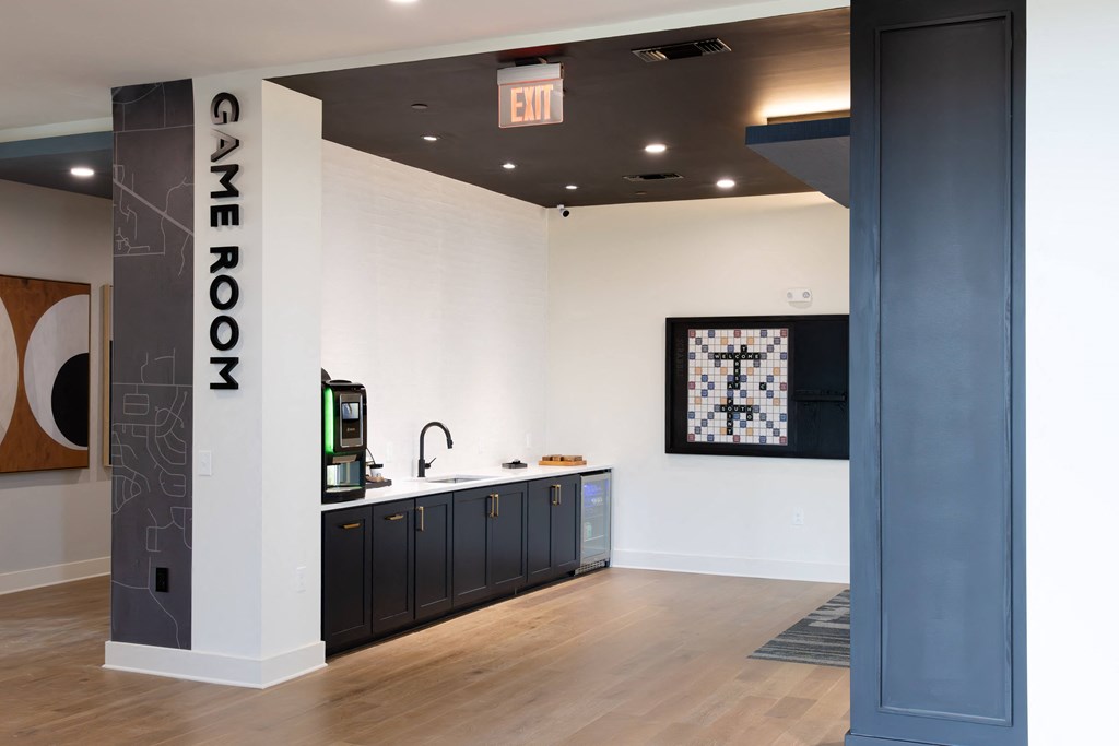 A room with a sign that says Game Room. at The Crest at South Point Apartments, Davenport