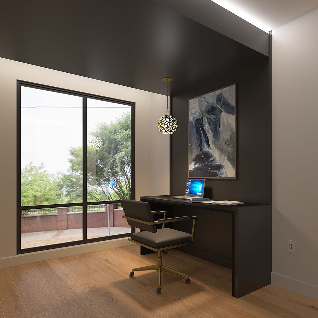 a home office with a large window and a black desk with a computer on itat The Crest at South Point, McDonough, 30253