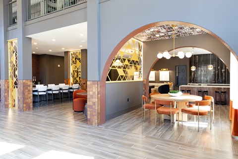 Community lounge with archway and dining seating at District on the Etowah Apartments, Canton, GA 30114