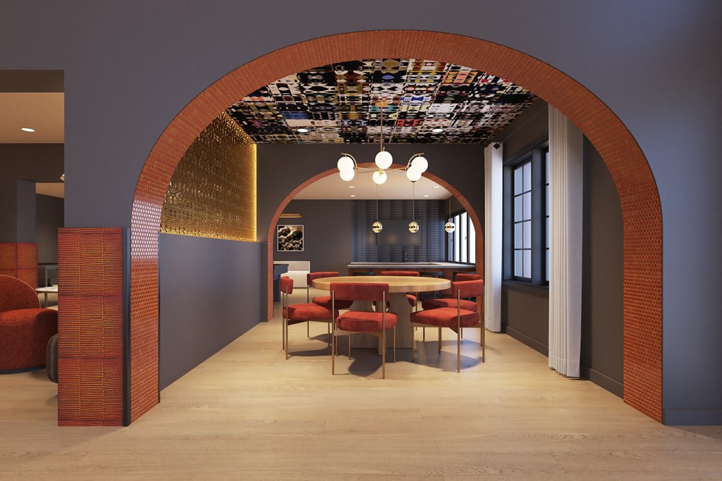 A room with a table and chairs under a ceiling covered in books.