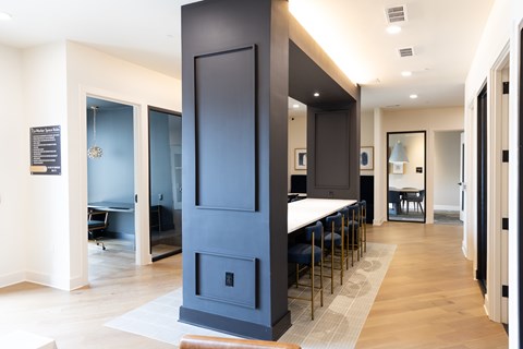A modern kitchen with a tall dark blue cabinet and a white countertop.
