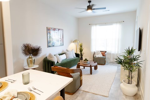 A dining room with a white table and chairs.