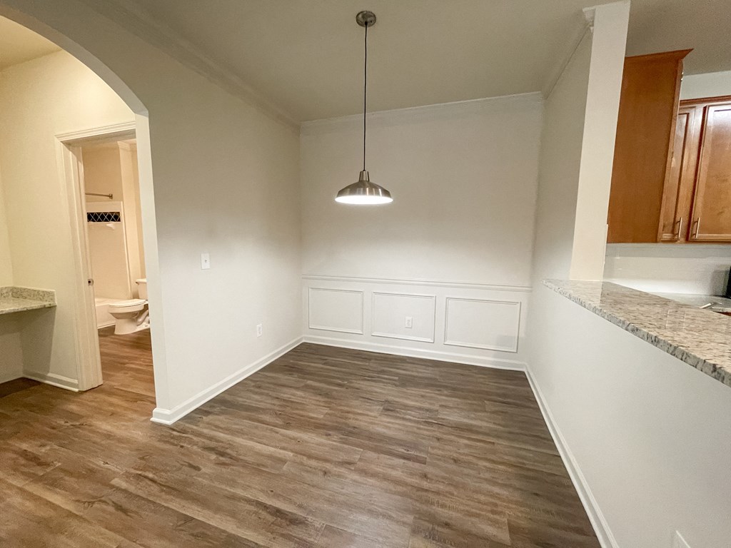 Dining Space with Wood Style Plank Flooring and Overhead Light located in Lawrenceville, GA