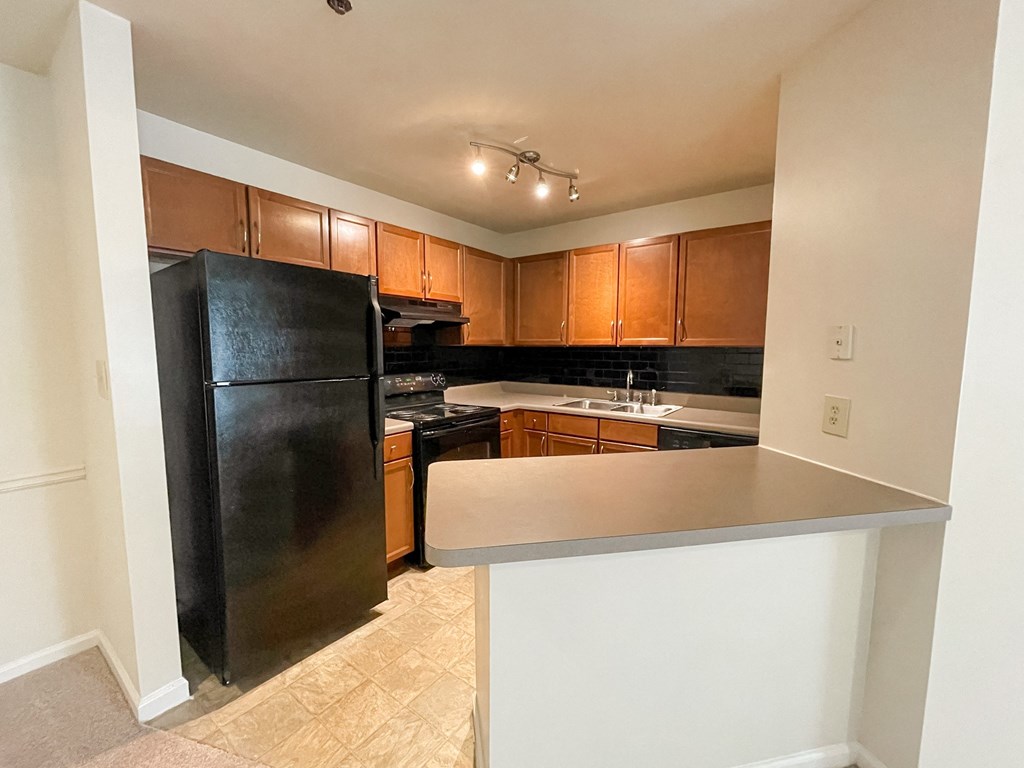 Drayton kitchen with wood cabinets and blank appliances located in Duluth, GA 30096