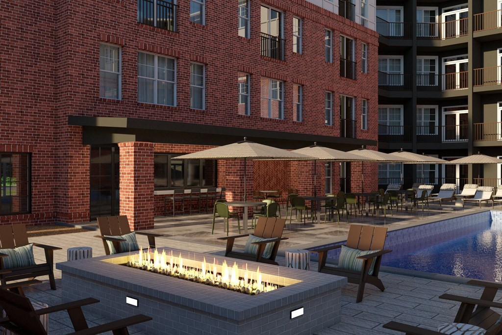 A poolside area with a fire pit and seating area.