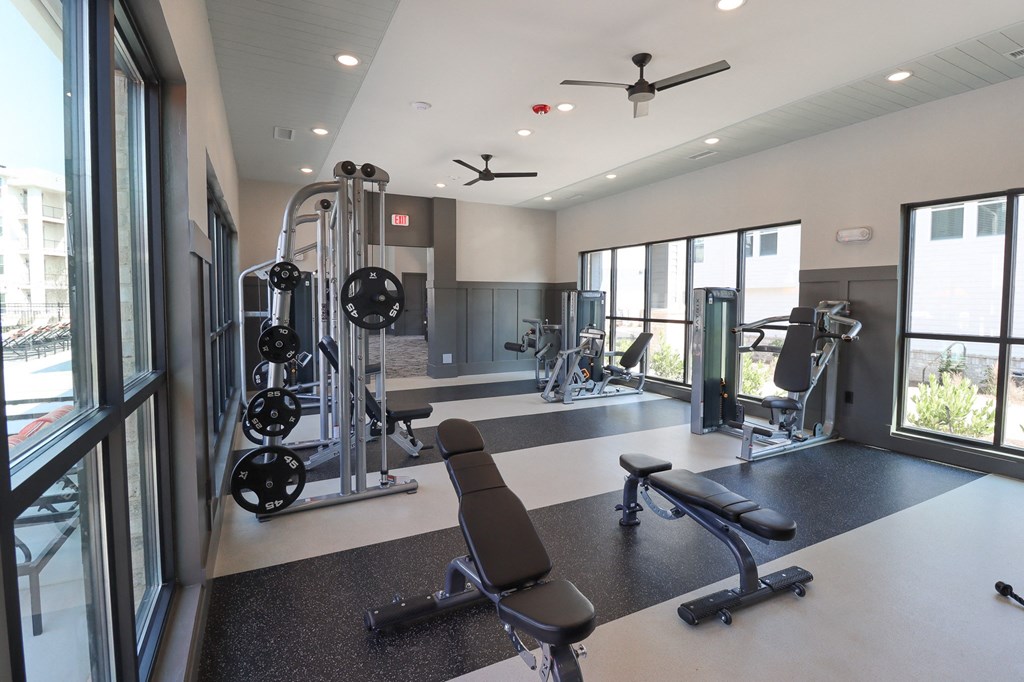 a gym with exercise equipment and windows in a building at The Crest at Acworth, Acworth, GA