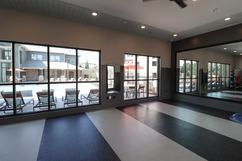 the lobby of a building with large windows and a black and white tile floor at The Crest at Acworth, Acworth, GA