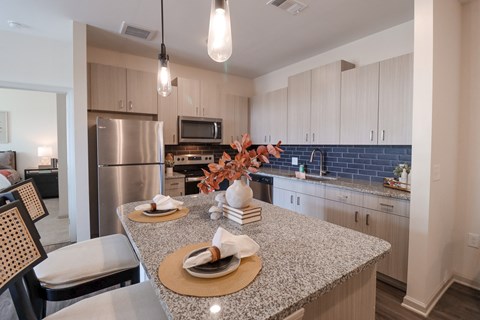 a kitchen with granite counter tops and stainless steel appliances at The Crest at Acworth, Acworth, Georgia