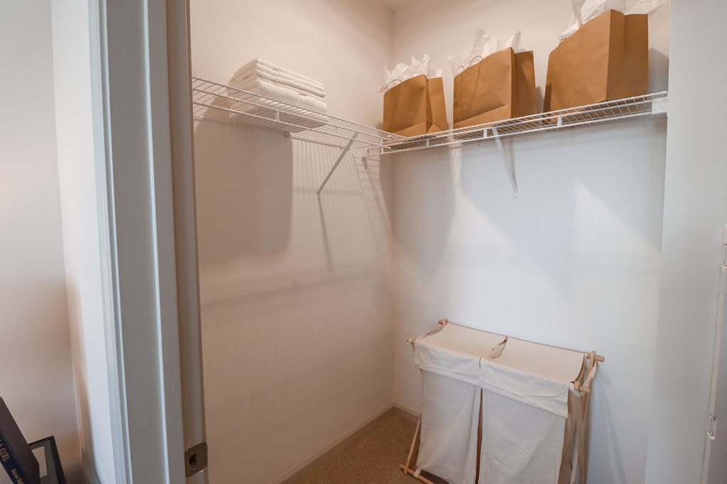 a walk in closet in a small room with boxes on the shelf and a white at The Crest at Acworth, Acworth, GA, 30102