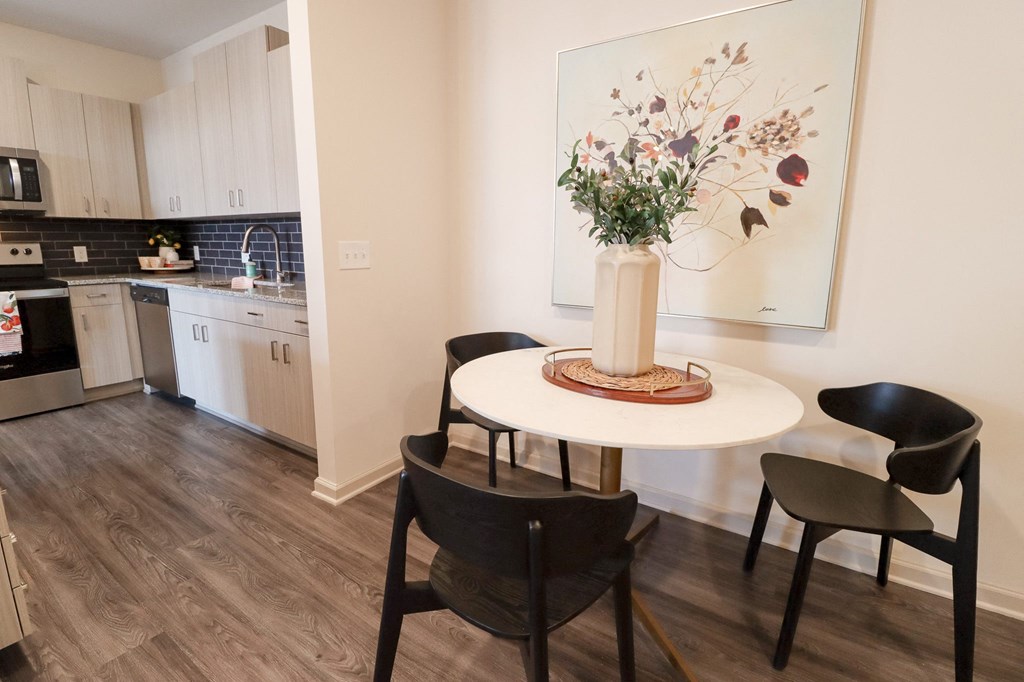 a kitchen with a table and chairs and a painting on the wall at The Crest at Acworth, Acworth