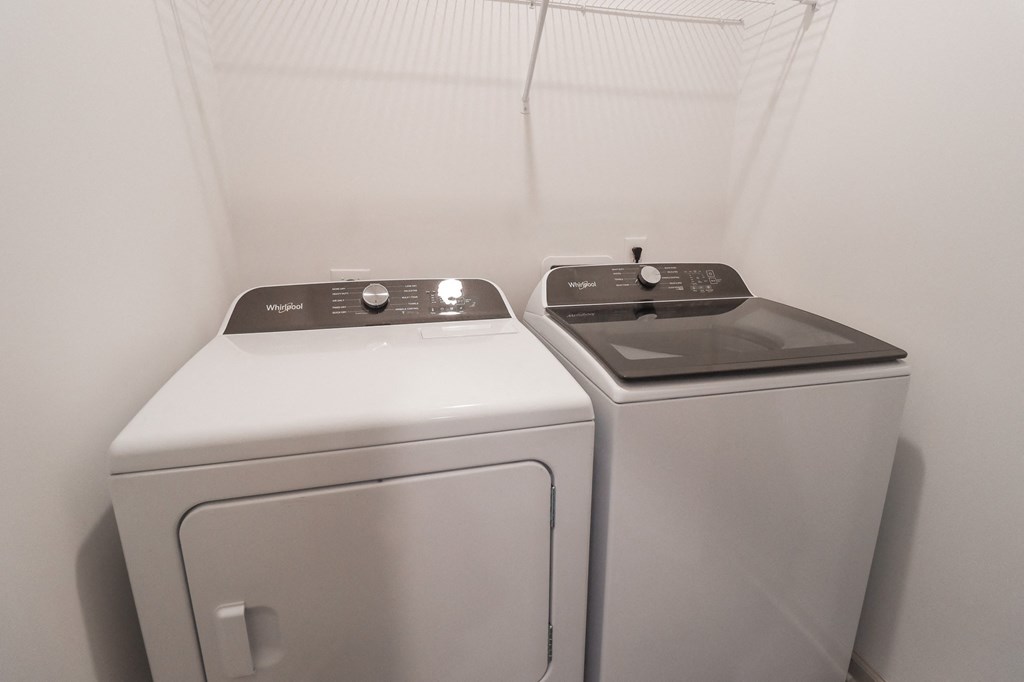a washer and dryer in a white room with white walls and a white at The Crest at Acworth, Georgia, 30102