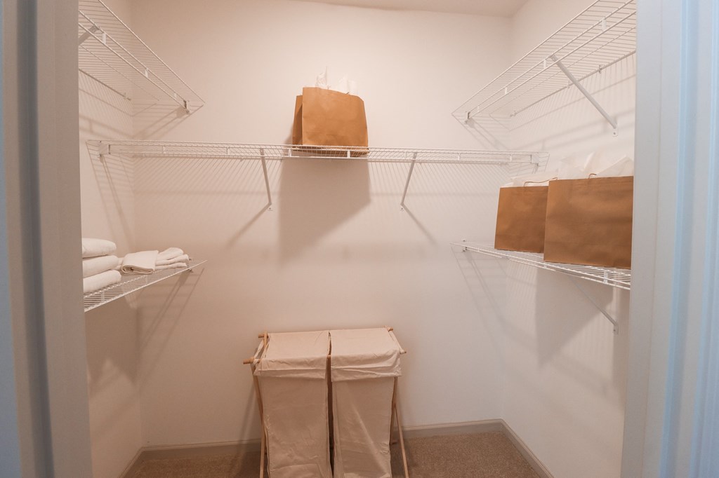 a walk in closet with bags and shelves in a white room at The Crest at Acworth, Georgia, 30102