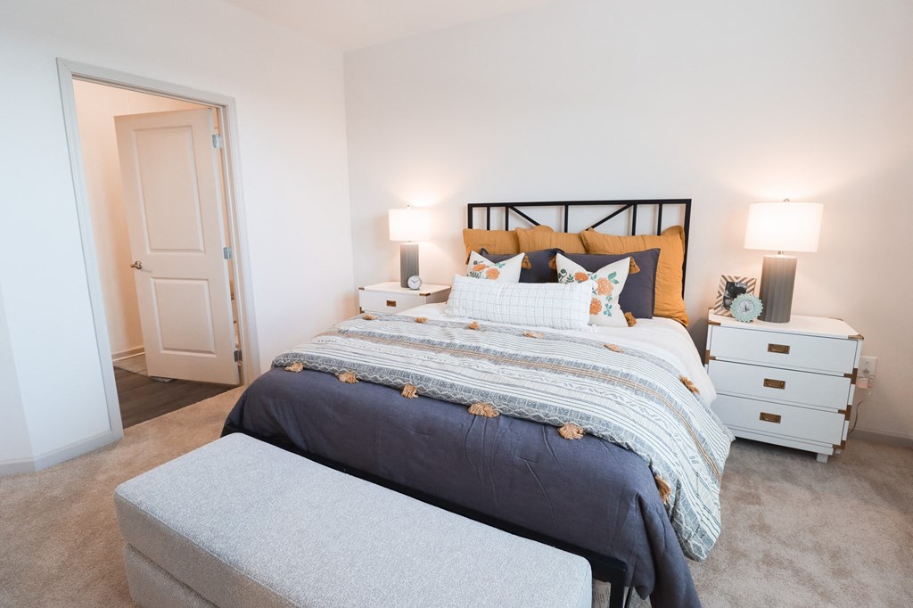a bedroom with a bed and two night stands and a closet at The Crest at Acworth, Acworth