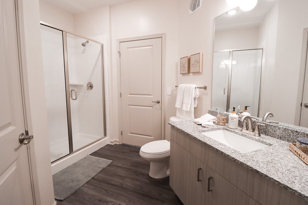 a bathroom with a toilet sink and shower at The Crest at Acworth, Acworth, GA