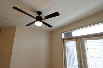 a ceiling fan in a room with a window and blinds at The Crest at Acworth, Acworth, GA