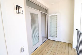 a bedroom with a medium sized window and a door that leads to a hallway at The Crest at Acworth, Acworth, Georgia