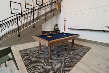 a pool table in a basement with a stairway in the background at The Crest at Acworth, Acworth, GA, 30102