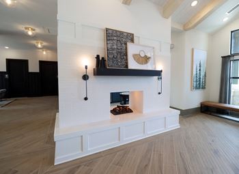 a living room with a fireplace and hardwood floors at The Crest at Acworth, Acworth, GA