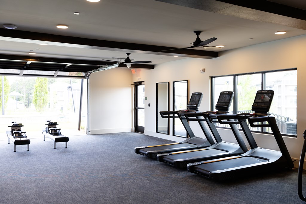 A gym with treadmills and exercise equipment at The Crest at Oakwood Apartments, Oakwood , GA, 30566