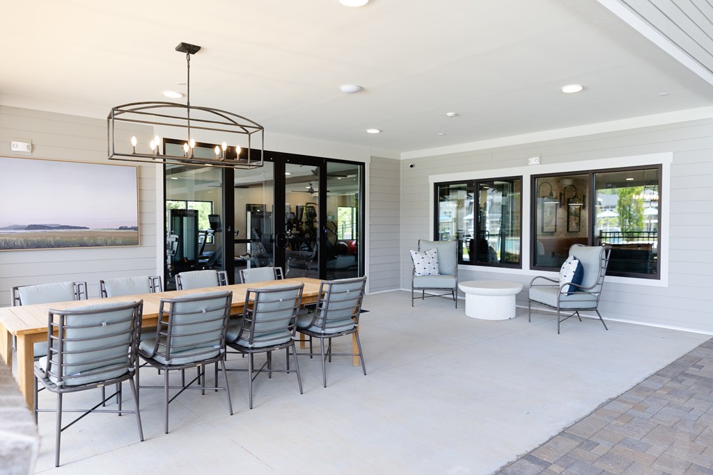 A modern dining room with a large table and chairs. at The Crest at Oakwood Apartments, Oakwood , Georgia