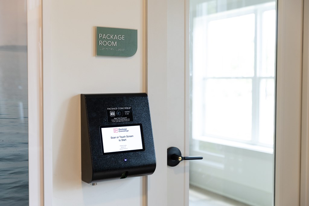 A package room sign is on a wall above a door. at The Crest at Oakwood Apartments, Georgia, 30566