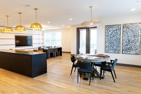 A modern dining room with a black table and chairs.