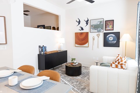 Table, painting on wall and couch at District on the Etowah Apartments, Canton, 30114