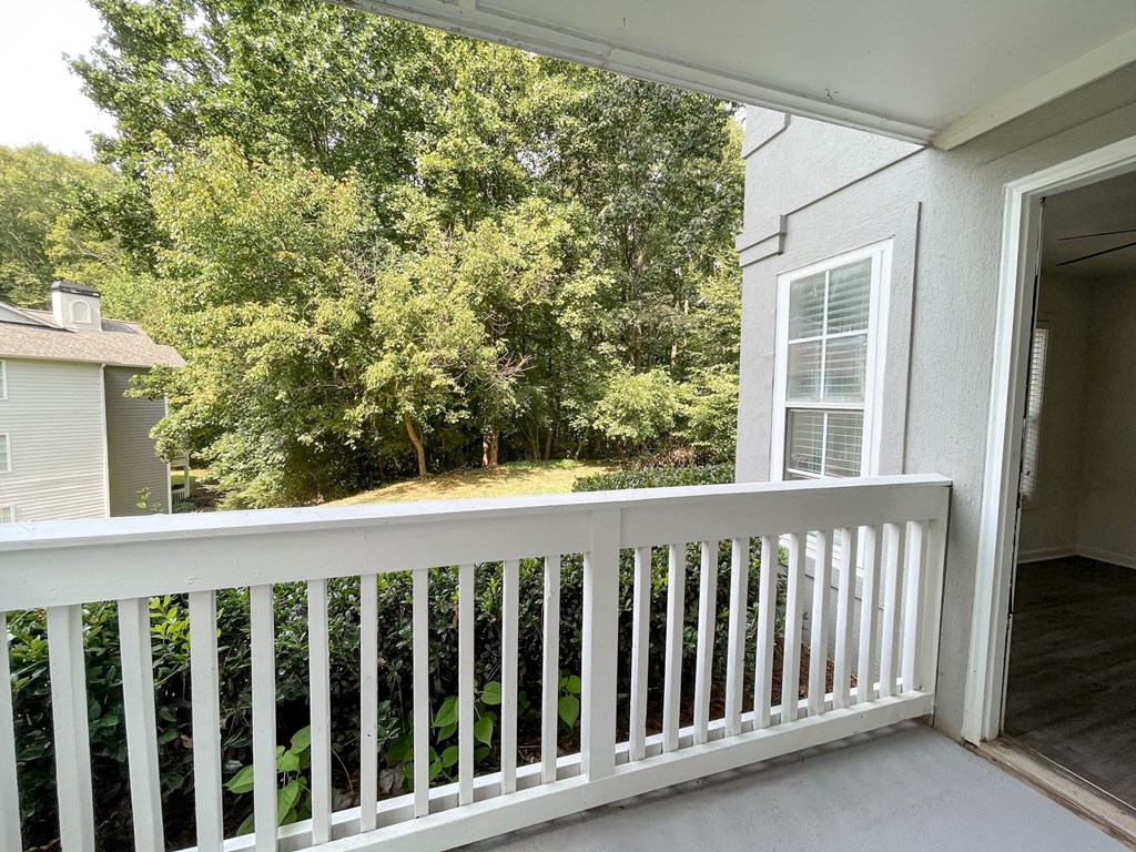 The Crest at Berkeley Lake St James renovated concrete patio with wooded view located in Duluth, GA 30096