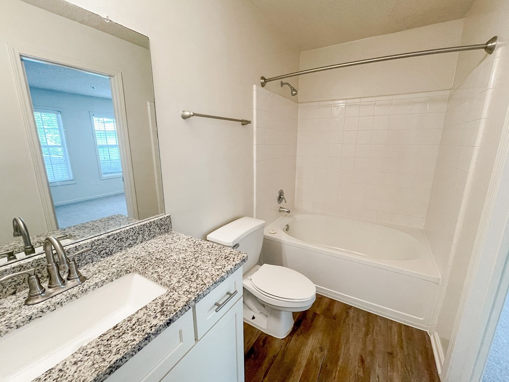 an empty bathroom with a sink toilet and tub at The Crest at Berkeley Lake, Duluth, 30096
