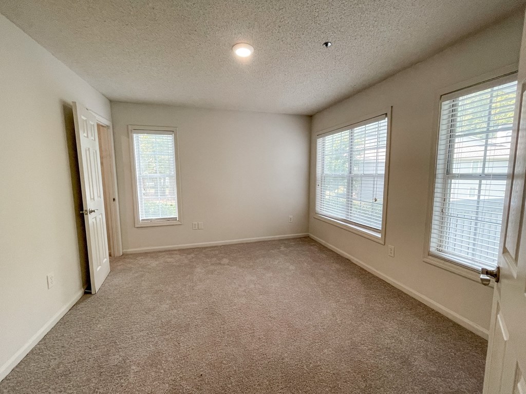 The Crest at Berkeley Lake St James renovated main bedroom with large windows located in Duluth, GA 30096