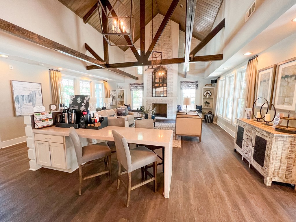 a dining room and living room with a table and chairs and a fireplace at The Crest at Berkeley Lake, Georgia, 30096