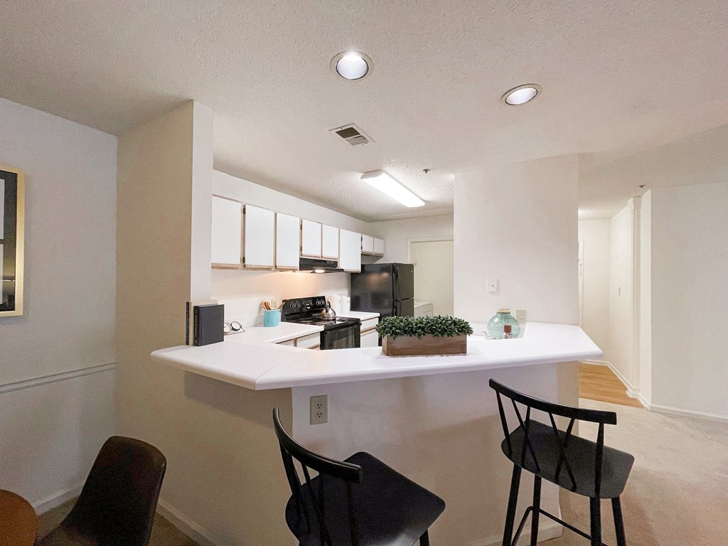 The Crest at Berkeley Lake model apartment  home kitchen with bar height countertop located in Duluth,GA