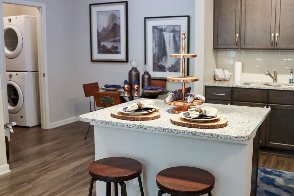 a kitchen with a counter with plates on it and a washing machine