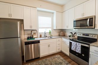 Apartment home kitchen with white shaker cabinets located in Naples,FL