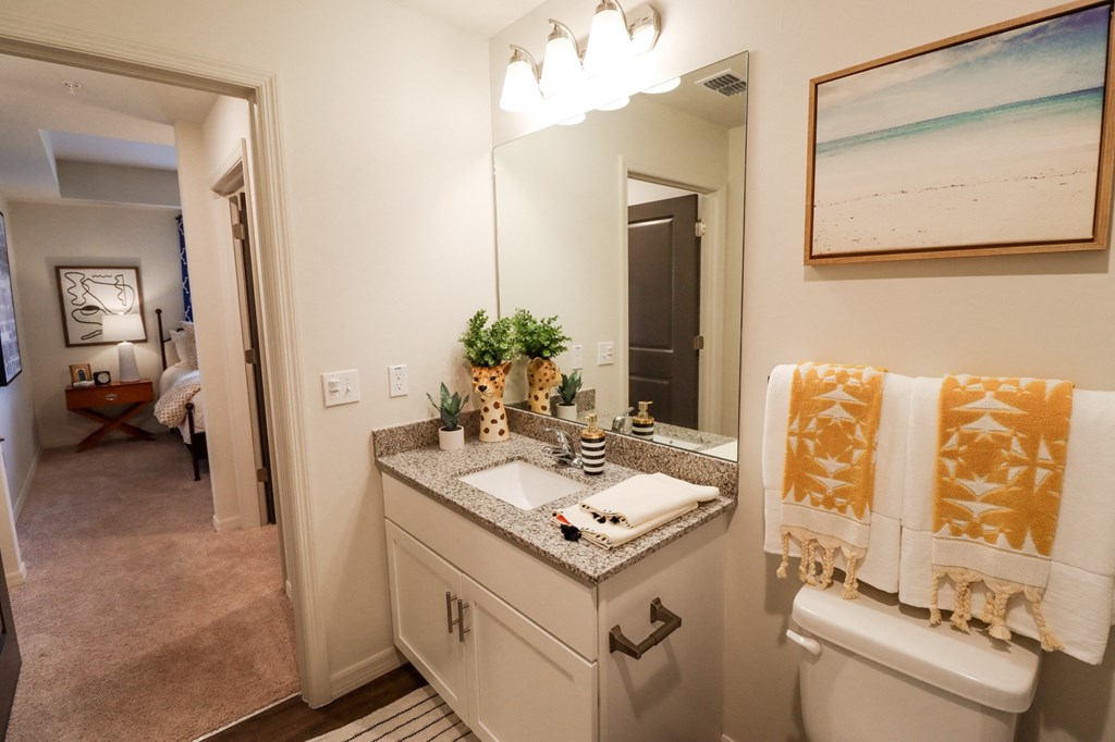 Apartment home primary bathroom vanity with granite countertop  at The Crest at Naples, Naples, FL