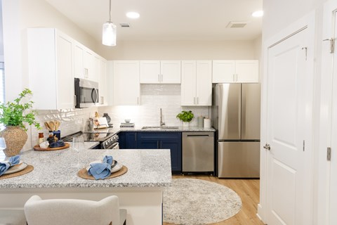 A modern kitchen with a dining table and chairs.