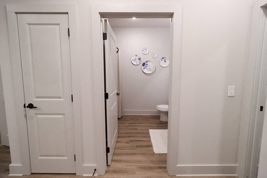 a hallway with white doors and plates on the wall