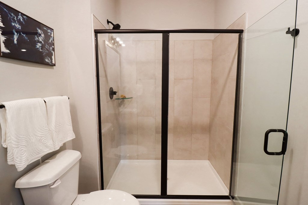 a small bathroom with a shower and a toilet at The Crest at South Point Apartments, Davenport , Georgia