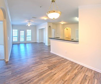 View of the dining area into the living area at The Crest at Sugarloaf, Lawrenceville - Photo Gallery 23
