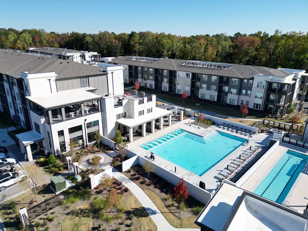 a rendering of a large swimming pool in front of an apartment building at The Wren Apartments, Lawrenceville, 30043