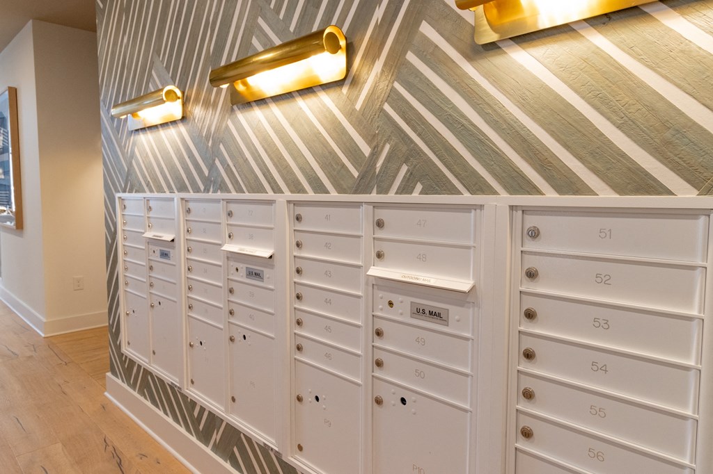 the mail room has plenty of cabinets and a bunch of drawers at The Wren Apartments, Lawrenceville, GA, 30043
